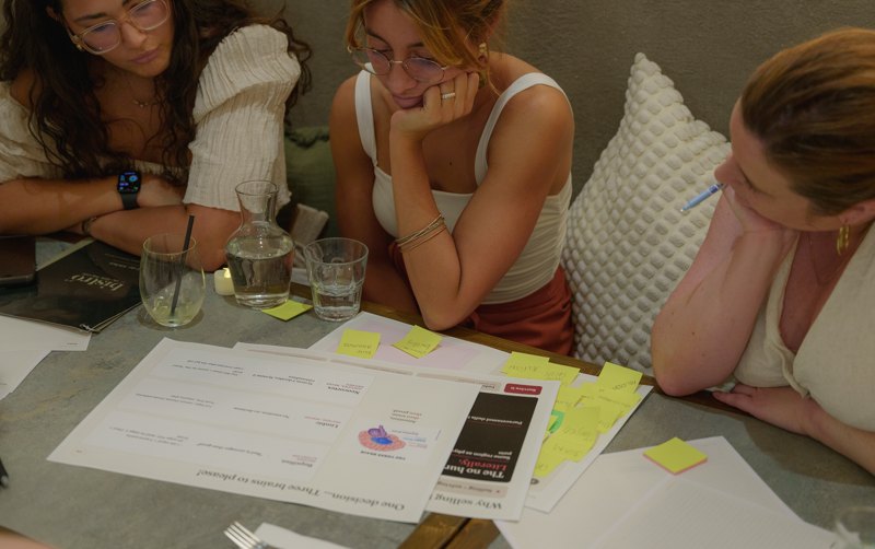 Attendees working through the printed Sales 101 worksheets