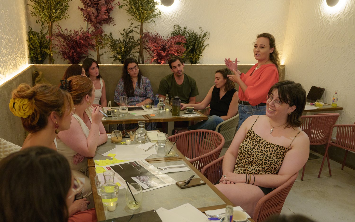 Sarah Malinowski teaching a Sales 101 workshop around a table in Madrid